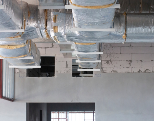 Close up of air ducts just underneath ceiling of building