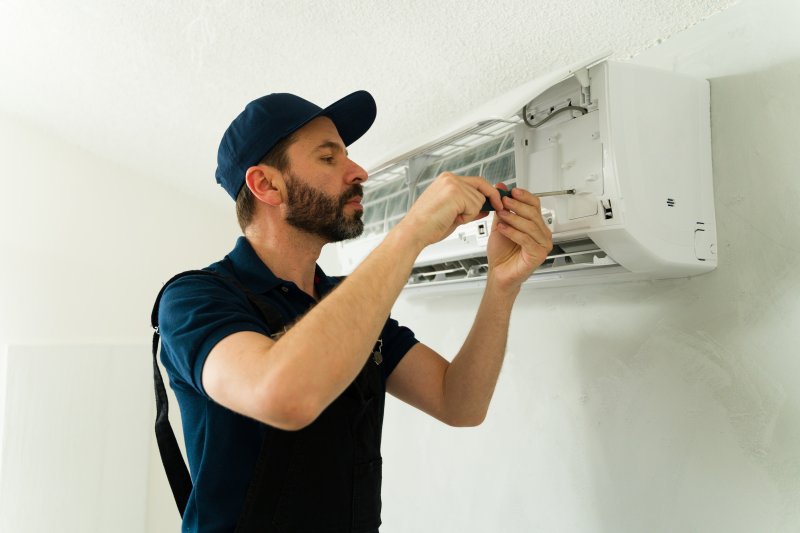 an HVAC professional doing A/C maintenance 