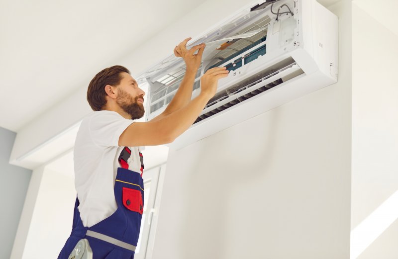 a man installing a new HVAC unit